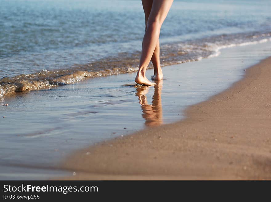 Girl's barefooted legs in water. Girl's barefooted legs in water