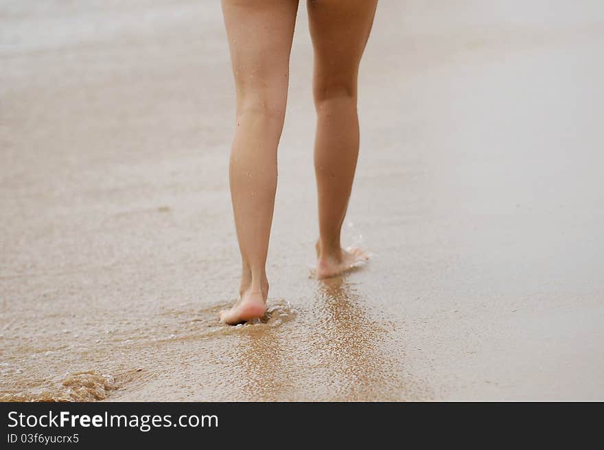 Girl's barefooted legs on a beach. Girl's barefooted legs on a beach