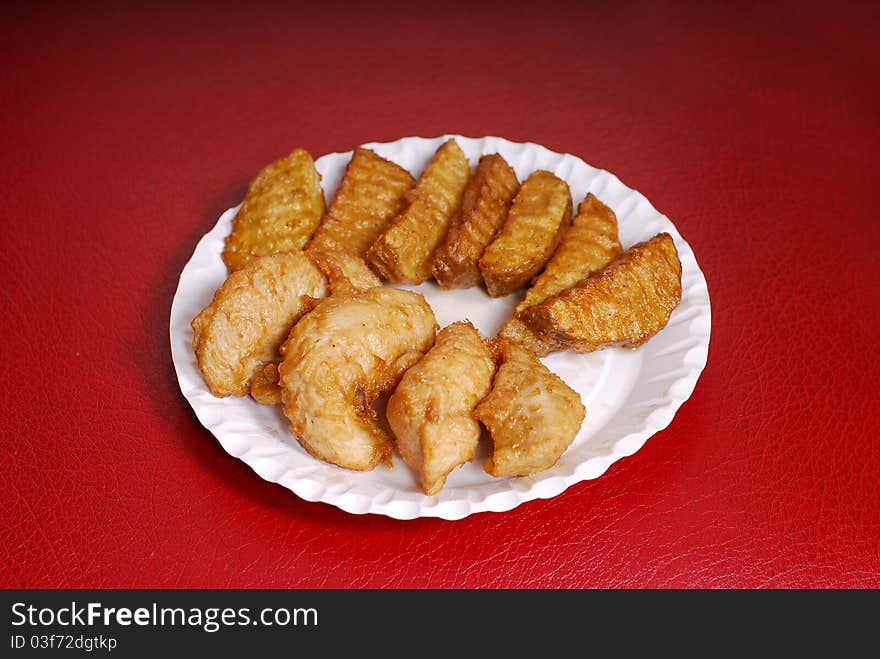 A plate with fried chicken on red