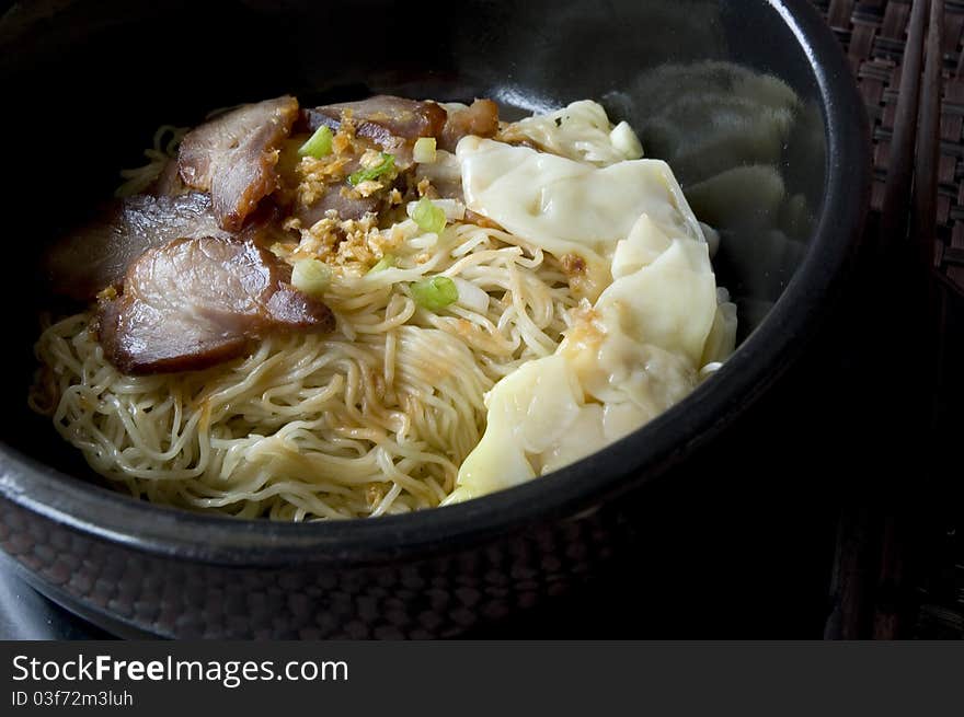 Asian noodle in black bowl