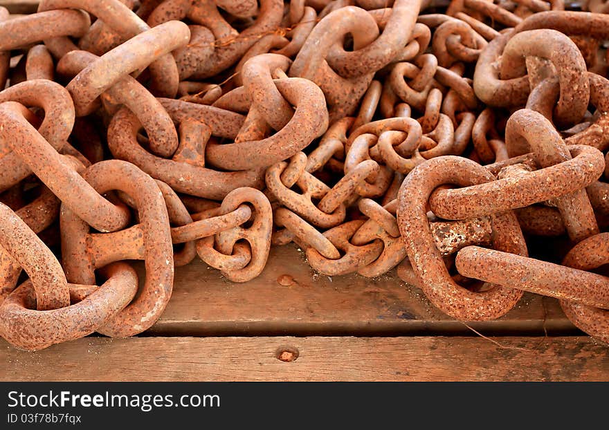 Rusty Chain On Wooden Background