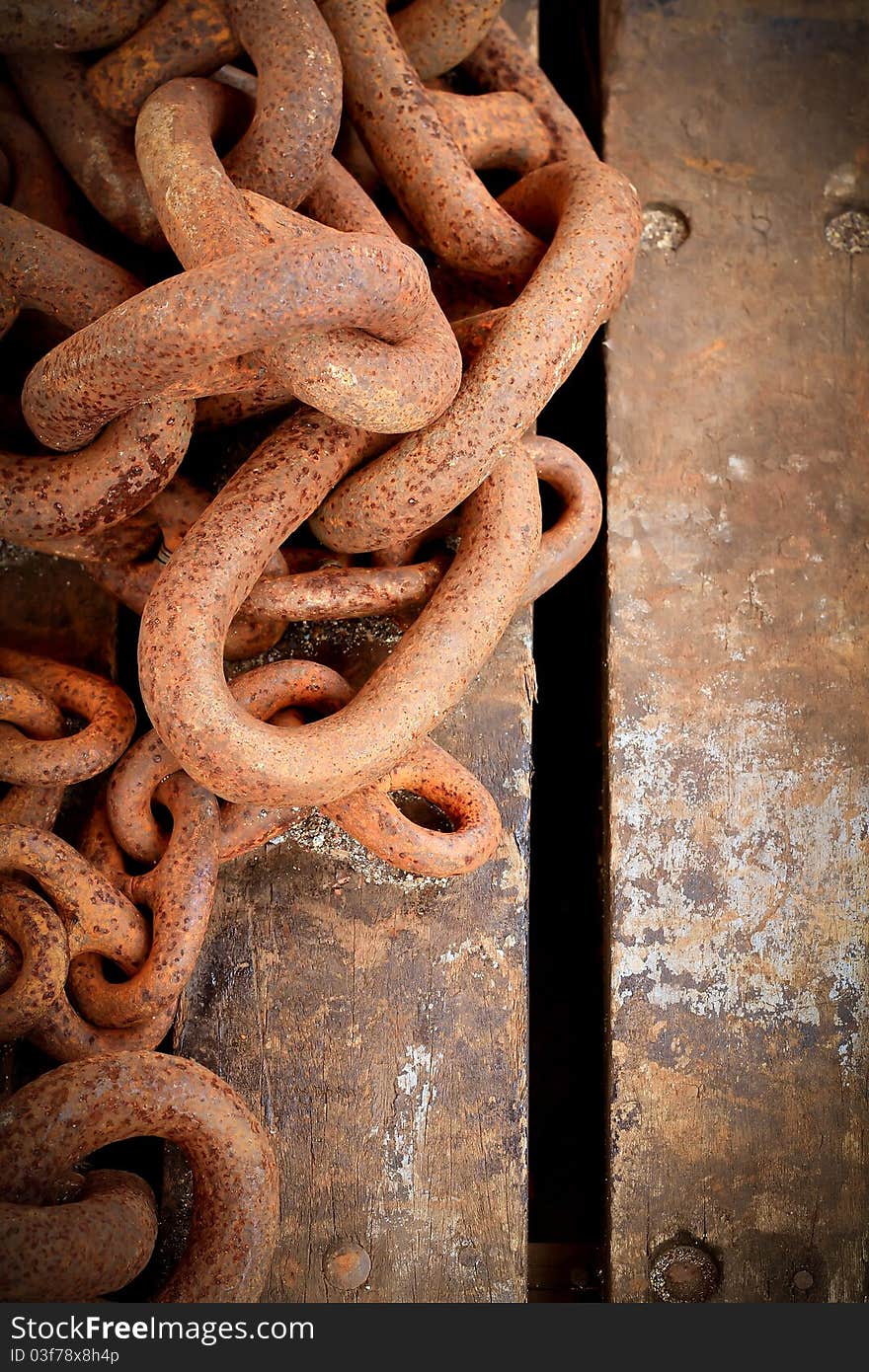 Rusty chain on wooden background