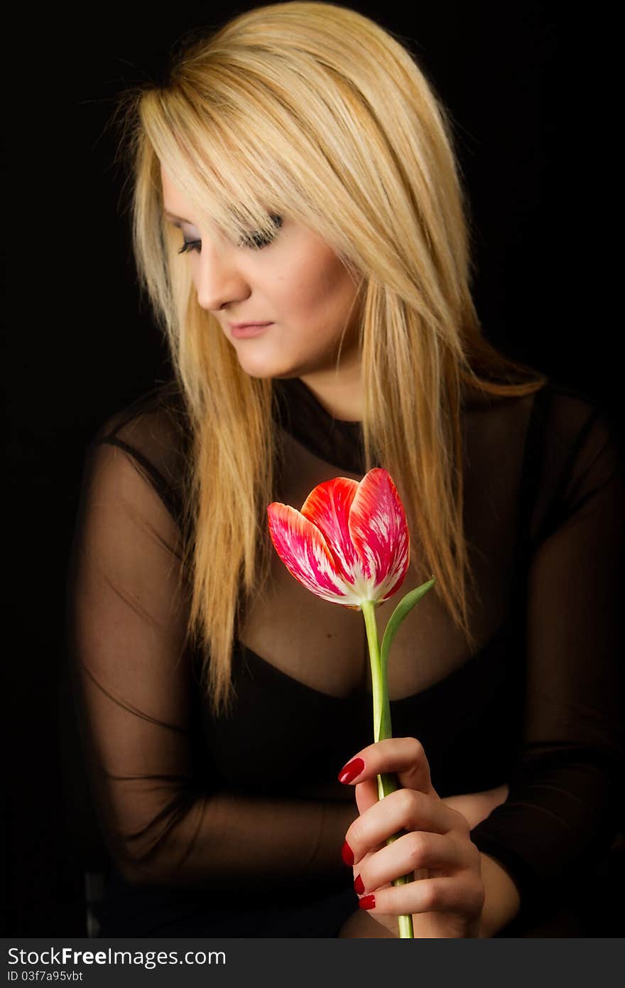 Stylish Woman with red tulip on white background