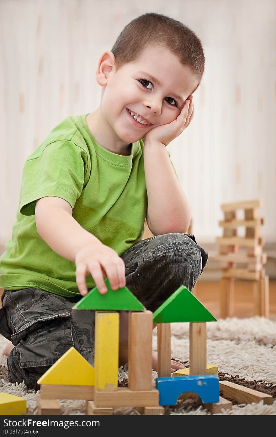 Little boy building a house with colorful wooden blocks. Little boy building a house with colorful wooden blocks