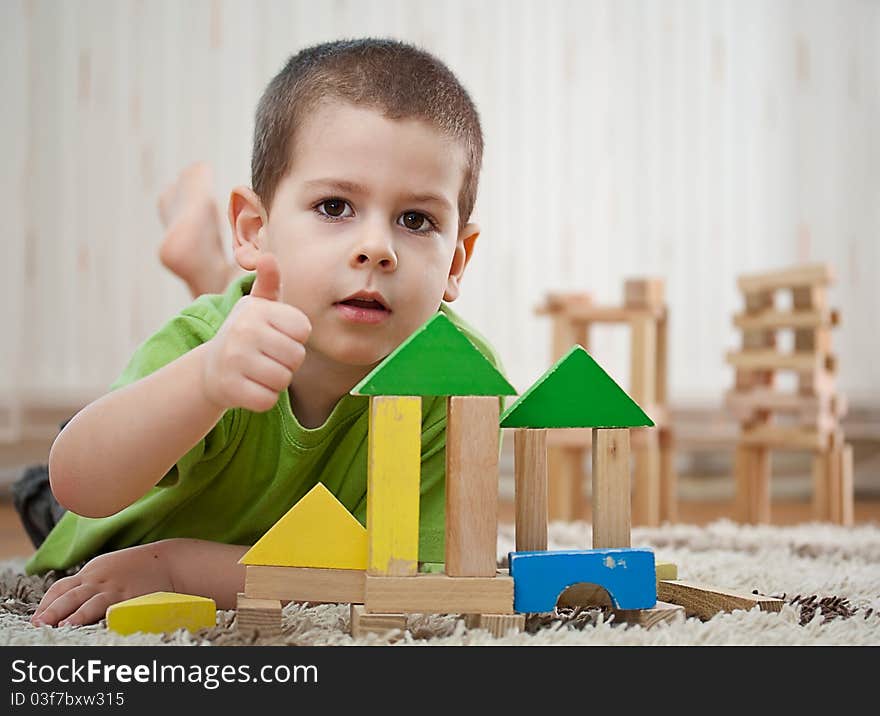 Little boy building a house with colorful wooden blocks. Little boy building a house with colorful wooden blocks