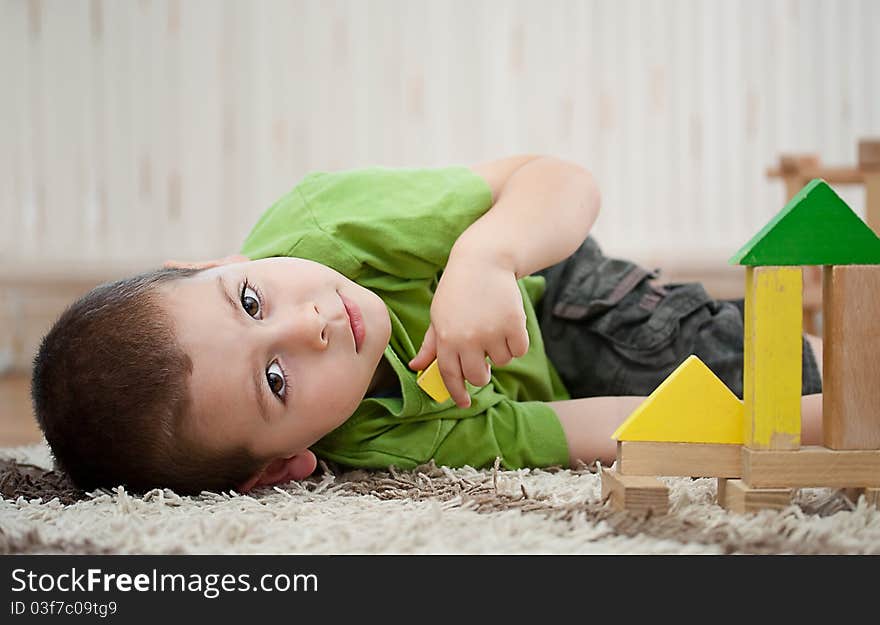 Little boy building a house with colorful wooden blocks. Little boy building a house with colorful wooden blocks