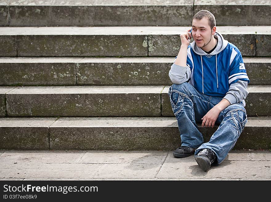 Young man sitting on stairs