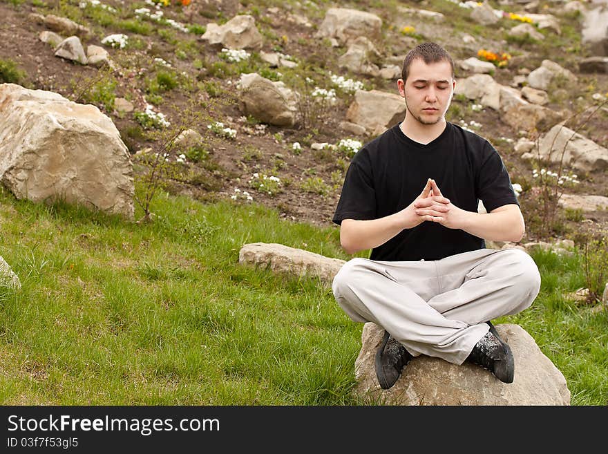 Man doing yoga at the park