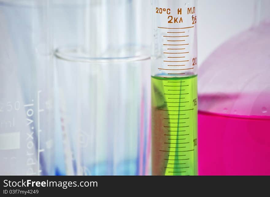 Flask, test tube on the background of glass bulbs in the office of chemistry. Flask, test tube on the background of glass bulbs in the office of chemistry.