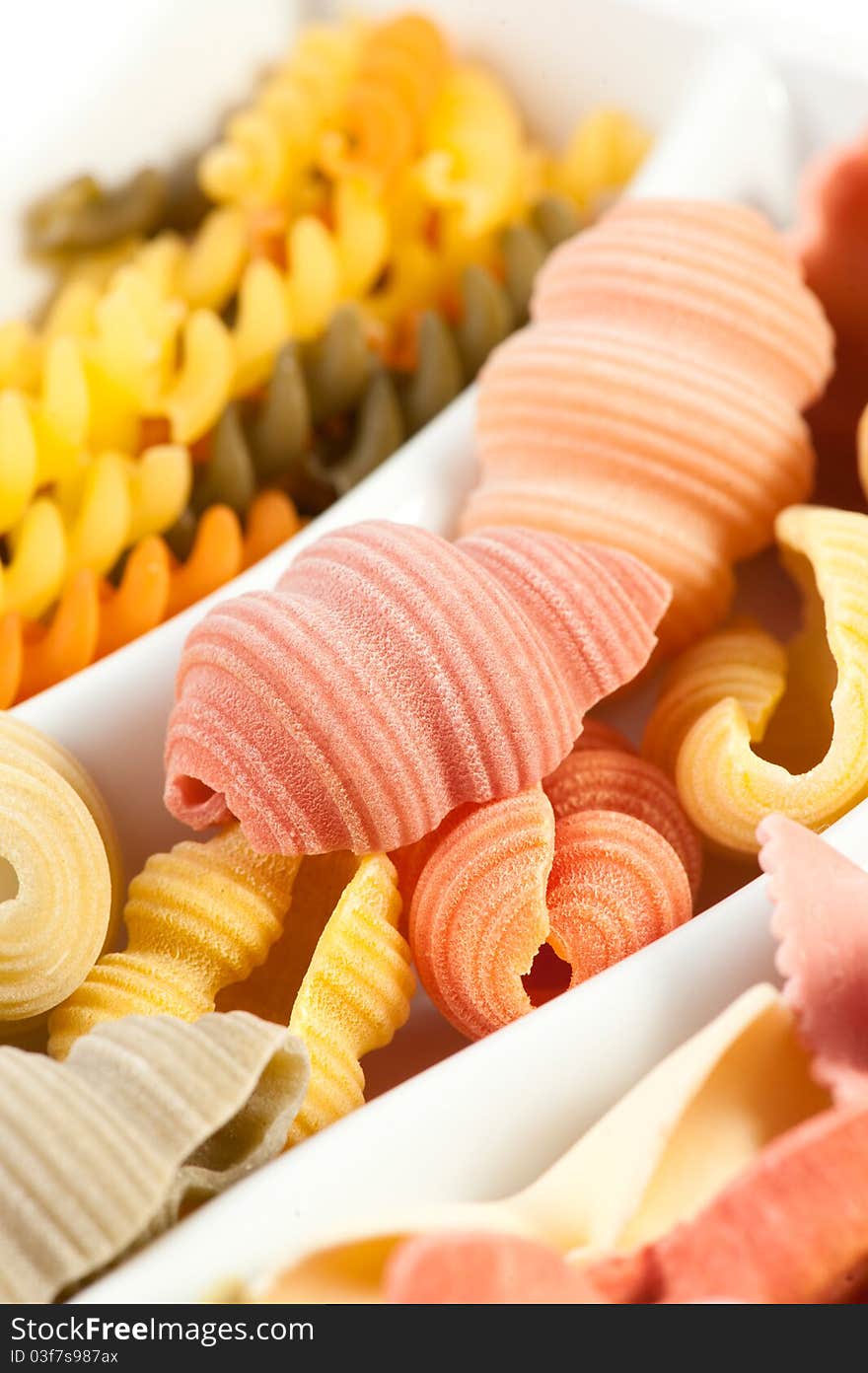 Different kinds of italian pasta on white background