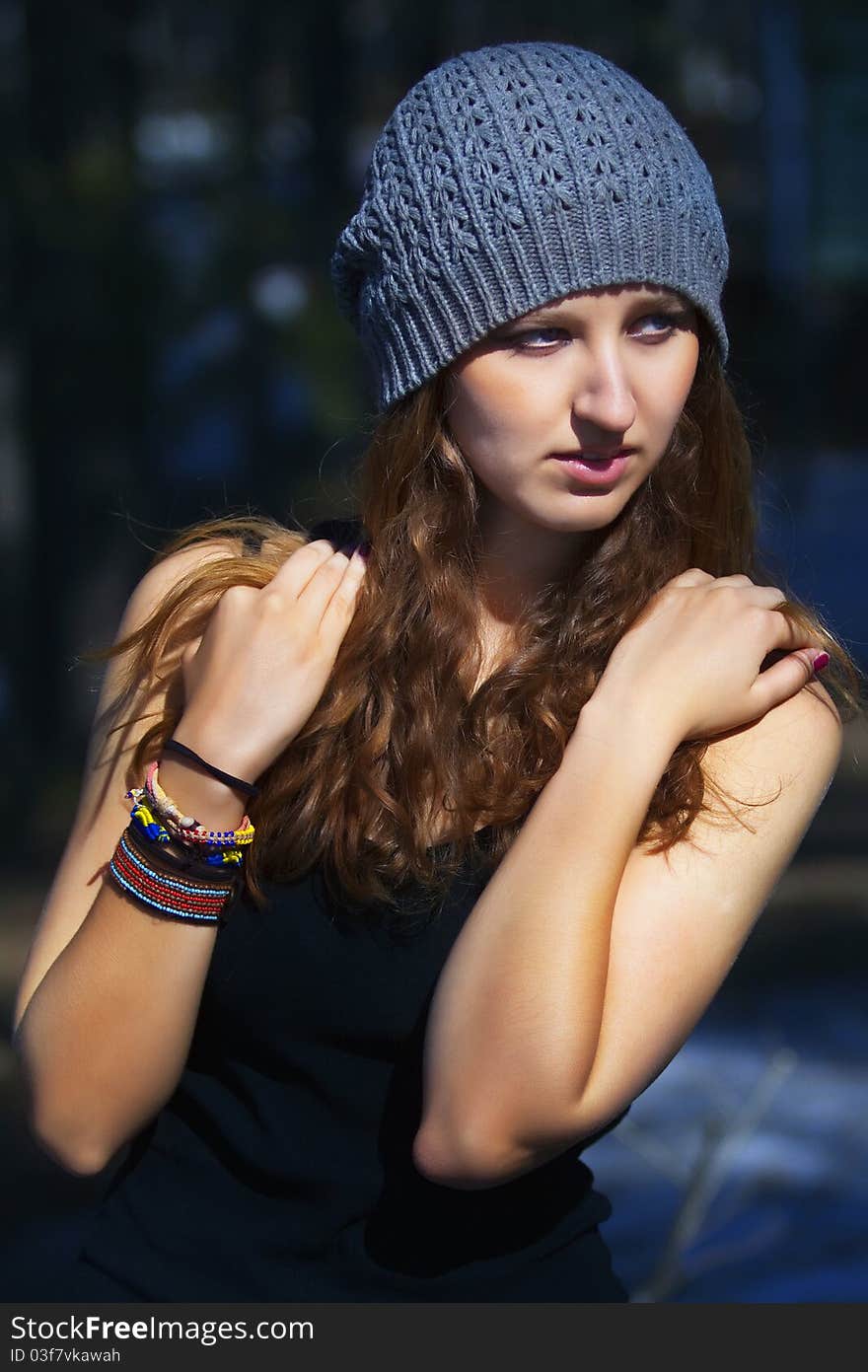 Beautiful smiling girl in a blue beret in park