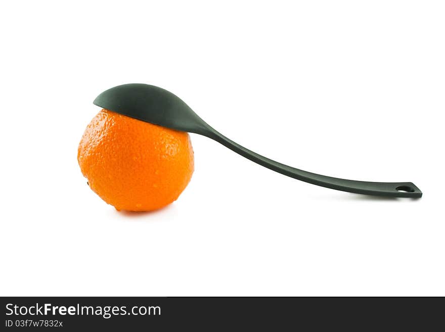 Large plastic serving spoon and orange