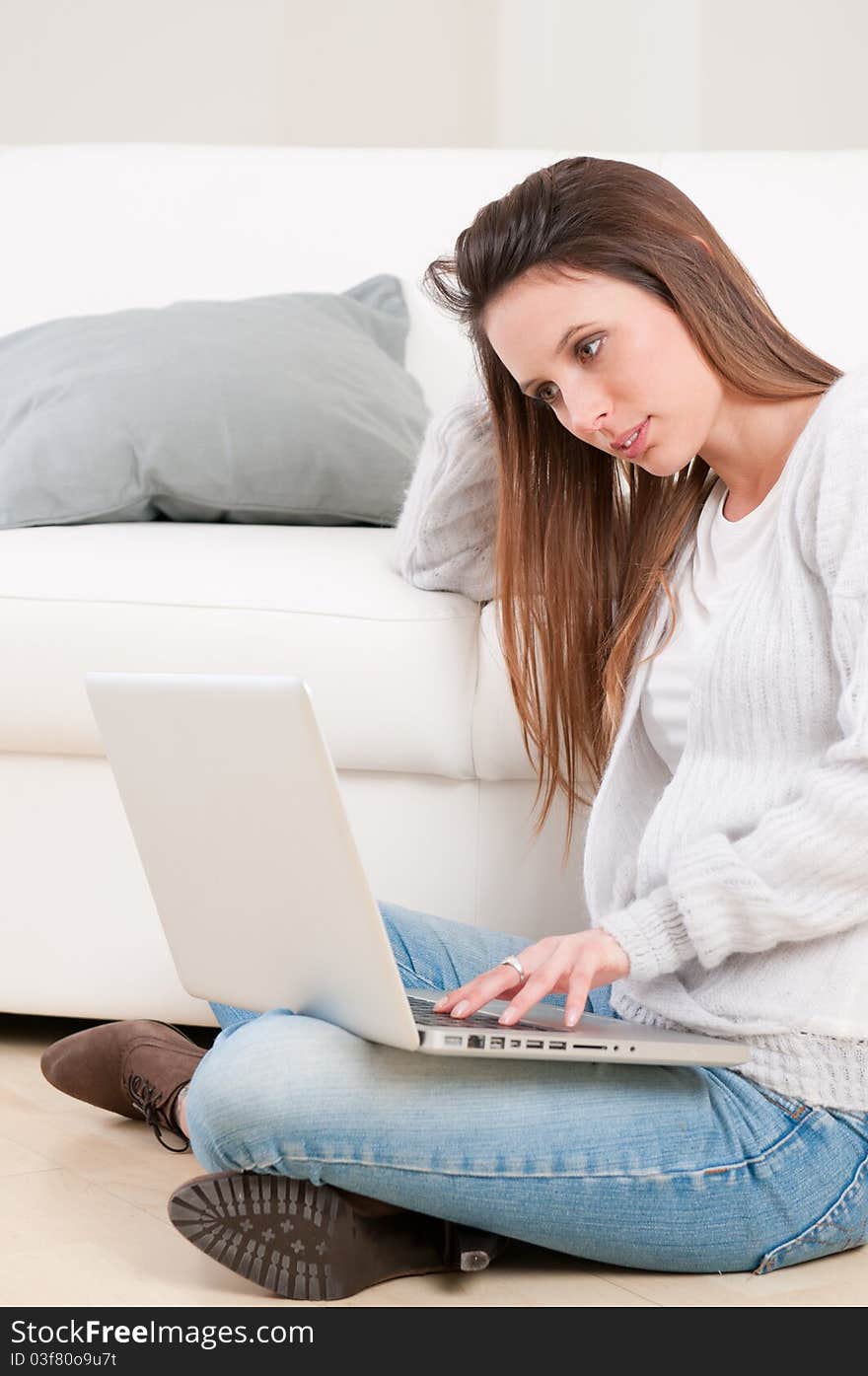 Absorbed young woman working on laptop