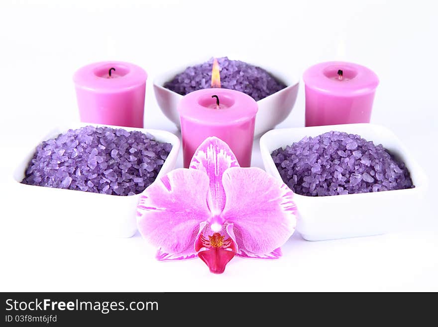 Lavender spa salt, an orchid flower and candles. Lavender spa salt, an orchid flower and candles