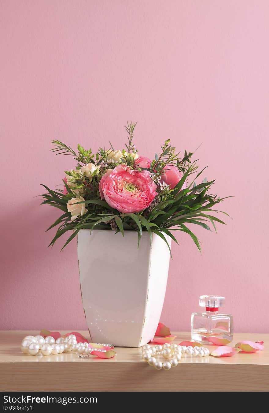 Bouquet of pink roses with pearl necklaces on pink background. Bouquet of pink roses with pearl necklaces on pink background