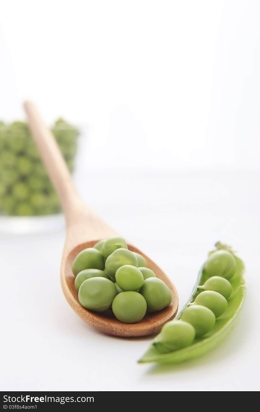 Fresh green pea in the pod on white background with soft shadow