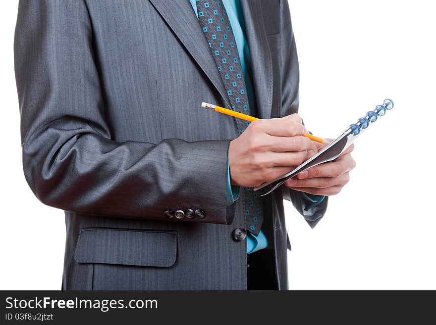 Businessman writing something in his notebook, notepad. Isolated on white background