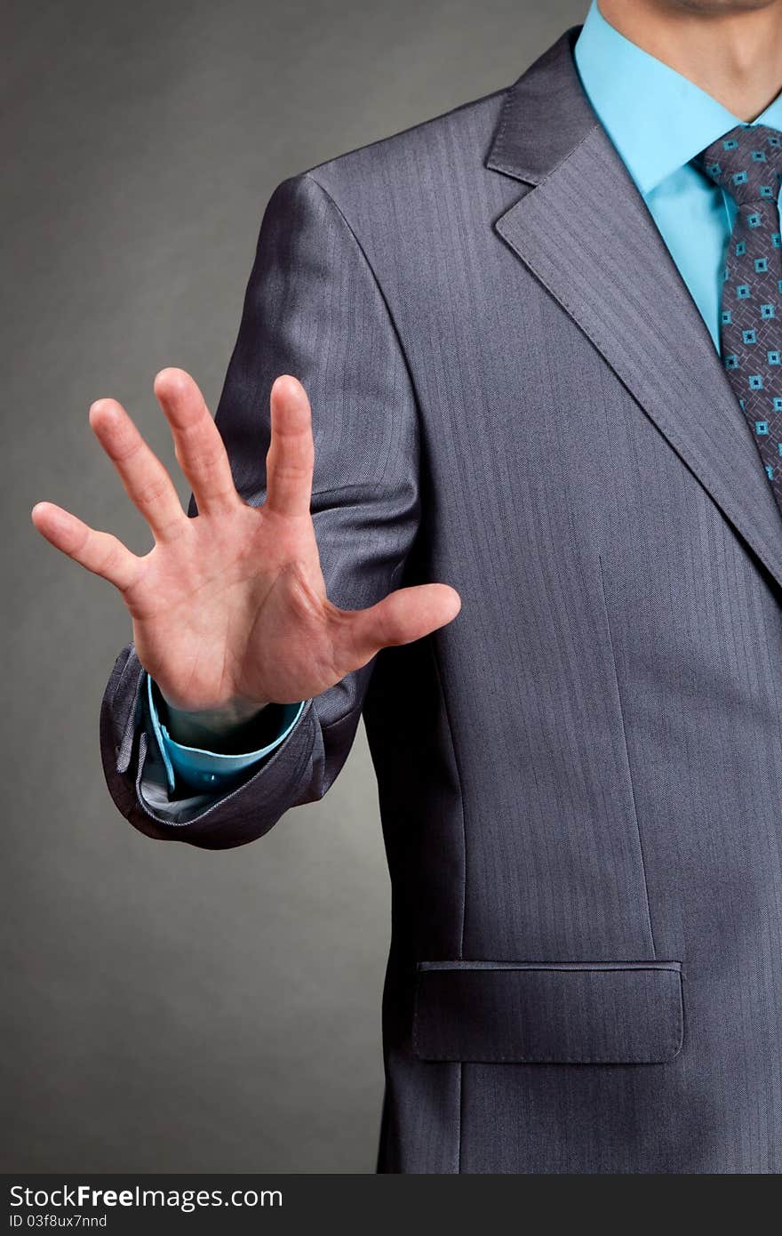 Businessman in suit and tie pointing the fingers palm in front of himself. Businessman in suit and tie pointing the fingers palm in front of himself