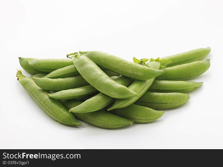 Fresh green pea in the pod on white background with soft shadow