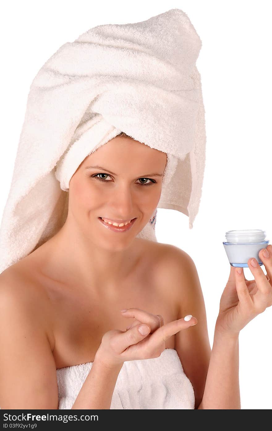 Young woman applying face cream. Young woman applying face cream.