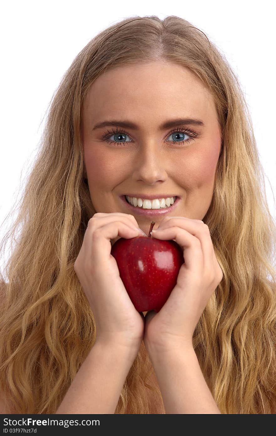 Beautiful blond caucasian young woman smiling and  holding a red apple, creating a heart with her hands. Beautiful blond caucasian young woman smiling and  holding a red apple, creating a heart with her hands