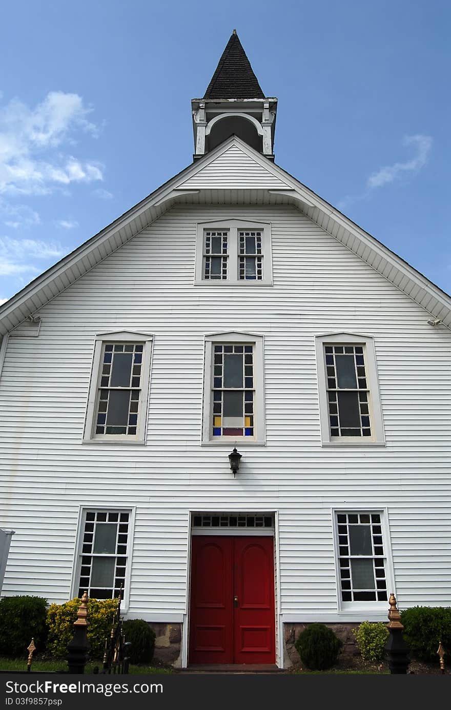 White wood church with red door. White wood church with red door