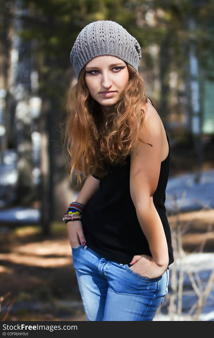 Beautiful smiling girl in a blue beret in park