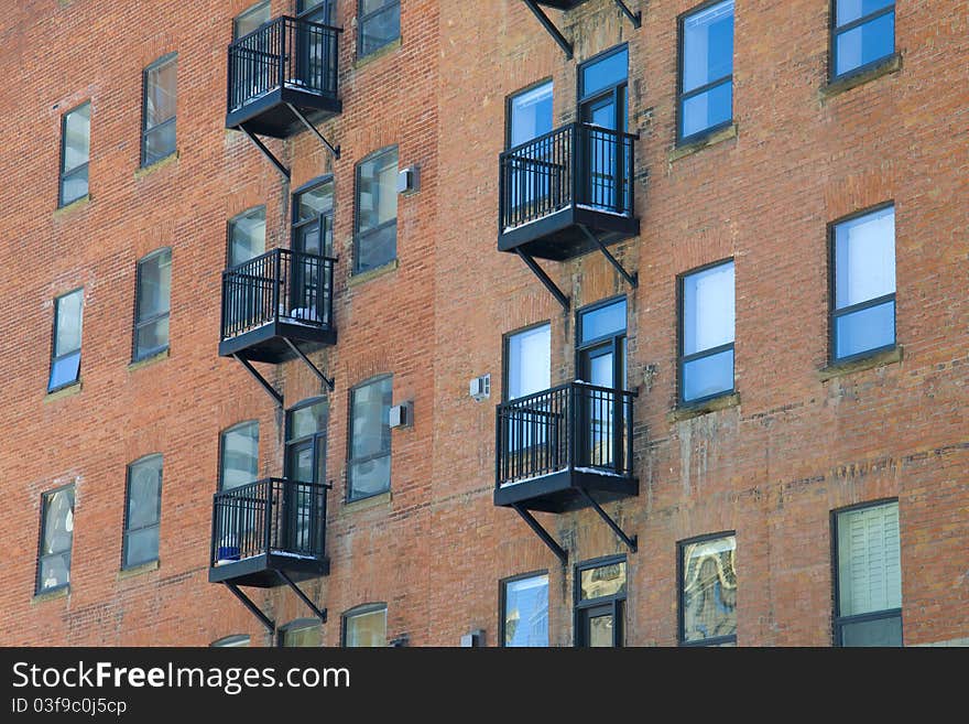 Fire escapes run down colorful apartment buildings in Calgary, Alberta, Canada