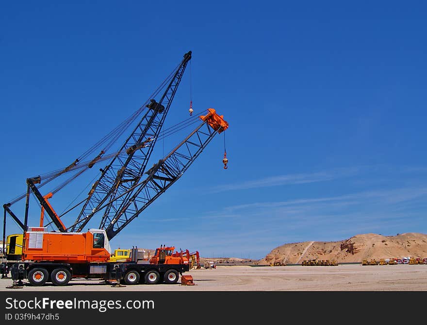 Three mechanical Cranes Parked in the Desert. Three mechanical Cranes Parked in the Desert