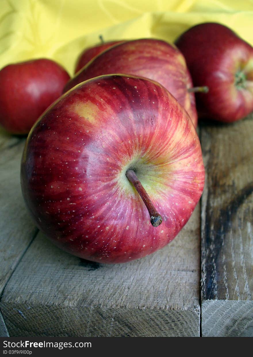 Red apples on a wooden table