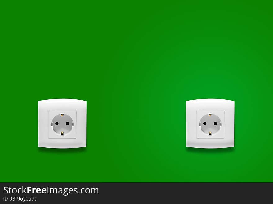 Electric consumption - electric outlet on green wall