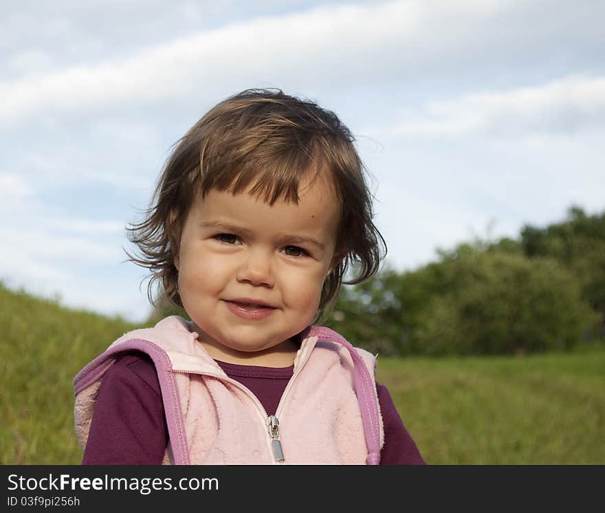 Portrait of a cute little girl smiling outdoors