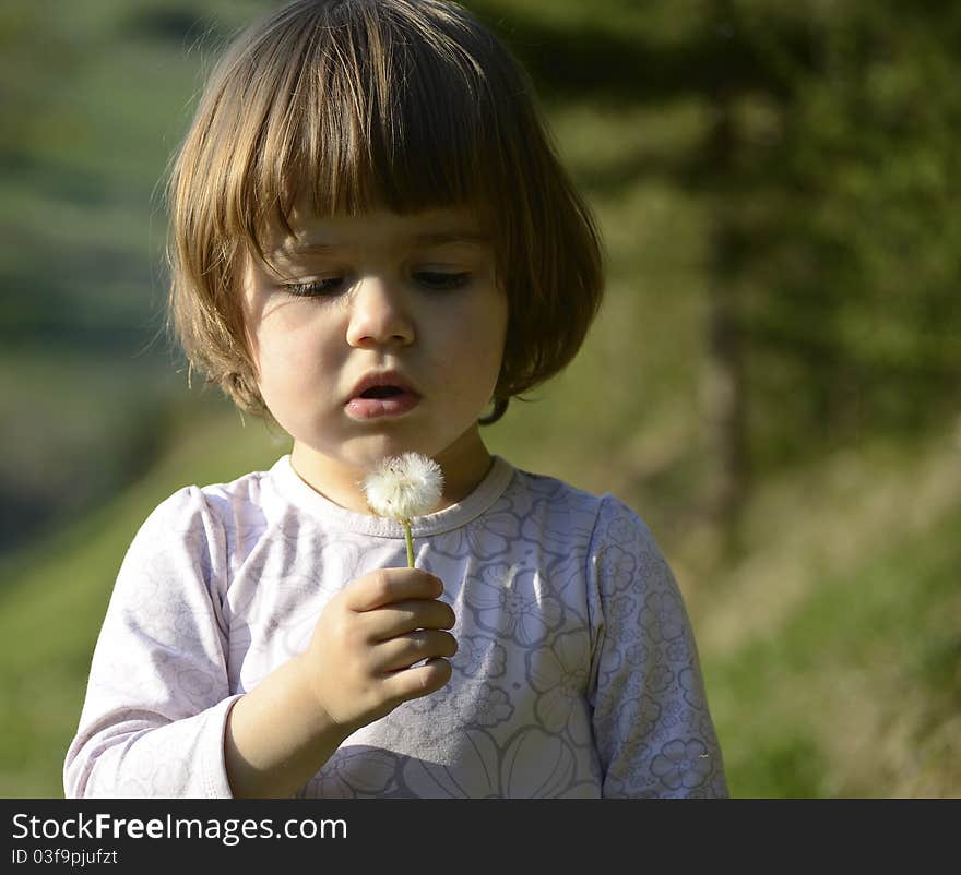 Child With A Dandelion Seed