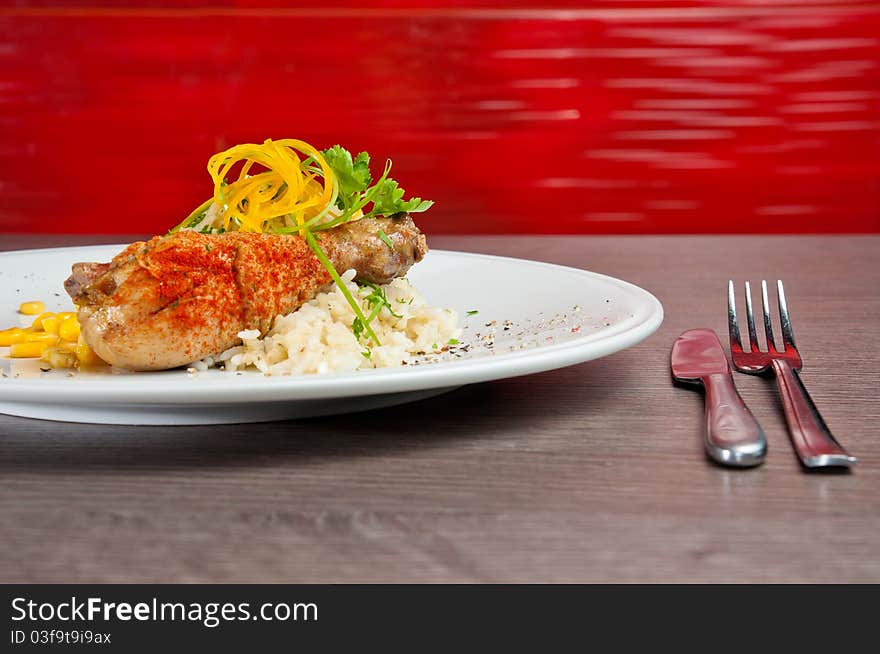 Chicken on a white plate with vegetables and rice. Chicken on a white plate with vegetables and rice