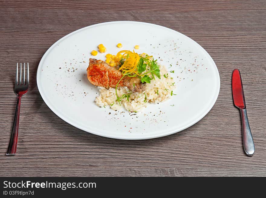 Chicken on a white plate with vegetables and rice. Chicken on a white plate with vegetables and rice