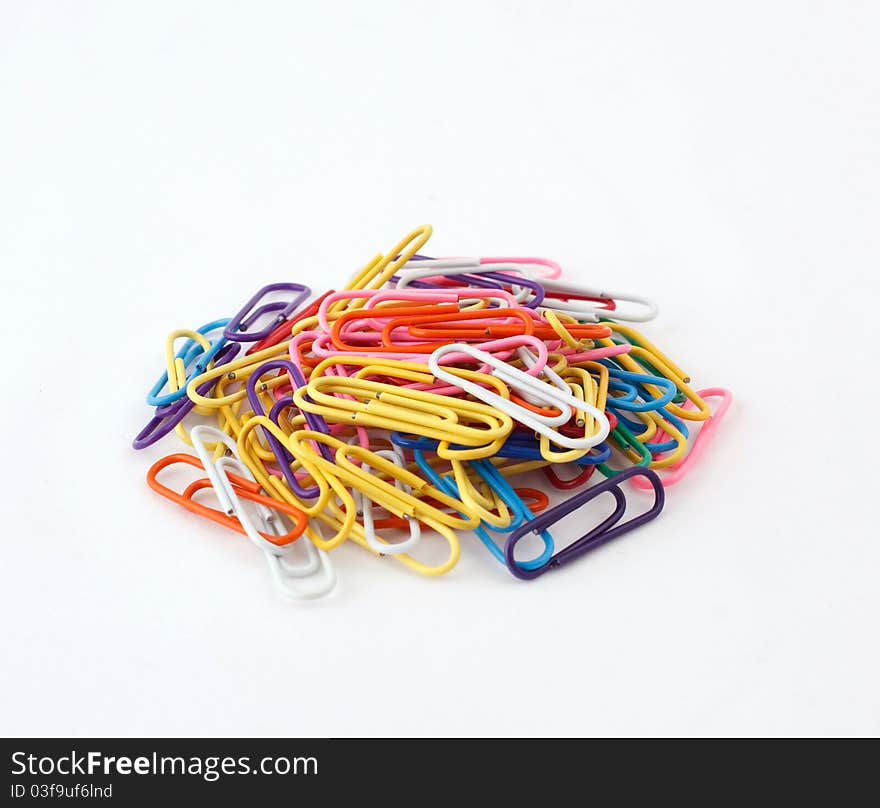 Colored paper clip on a white background