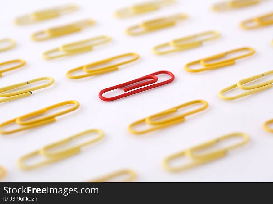 Colored paper clip on a white background