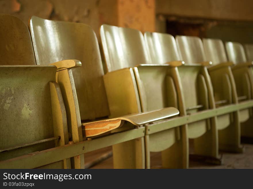 A series of old wooden cinema seats