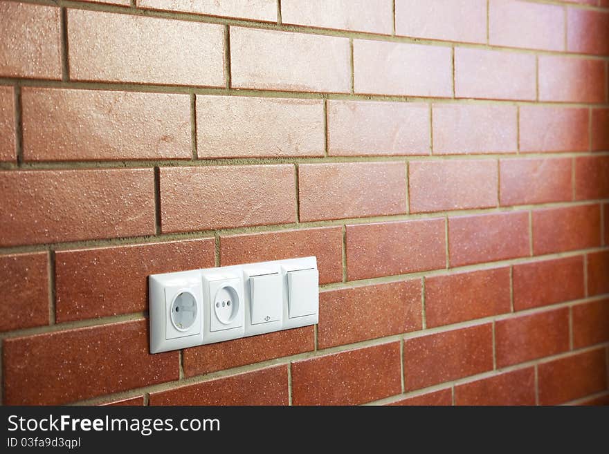 Power outlets on the brick wall / horizontal / photo. Power outlets on the brick wall / horizontal / photo