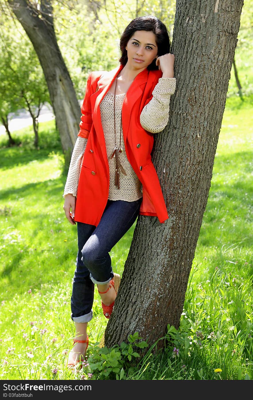 Beautiful brunette girl in red coat