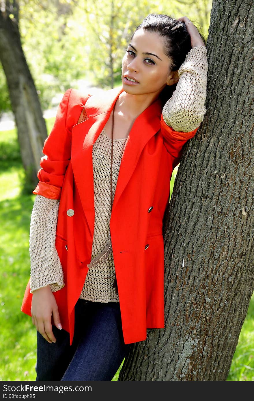 Beautiful brunette girl in red coat