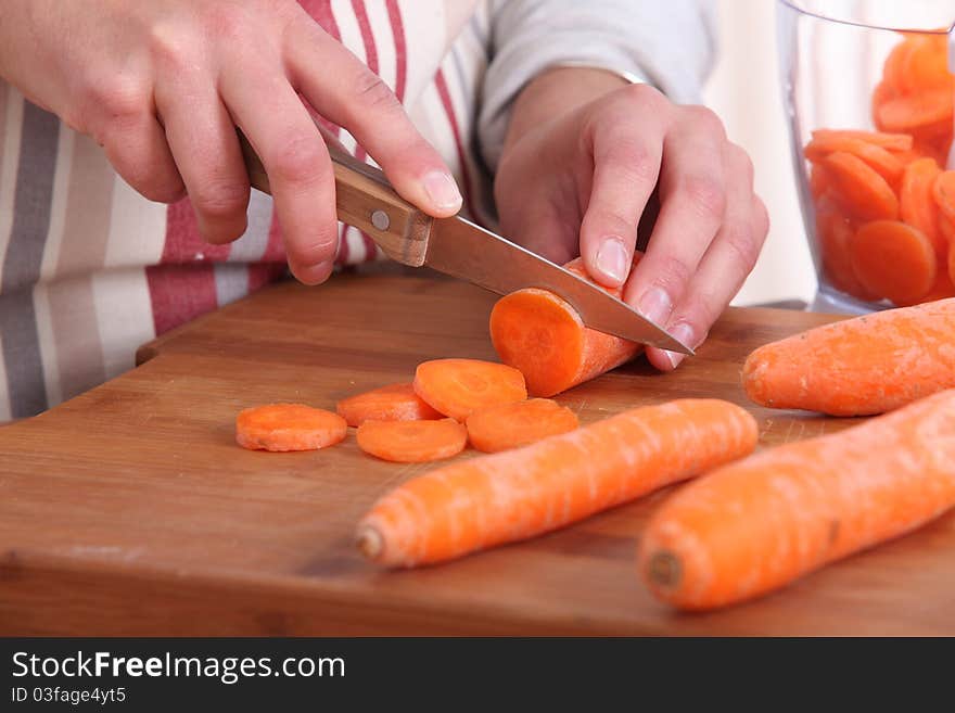 Cook cutting carrots