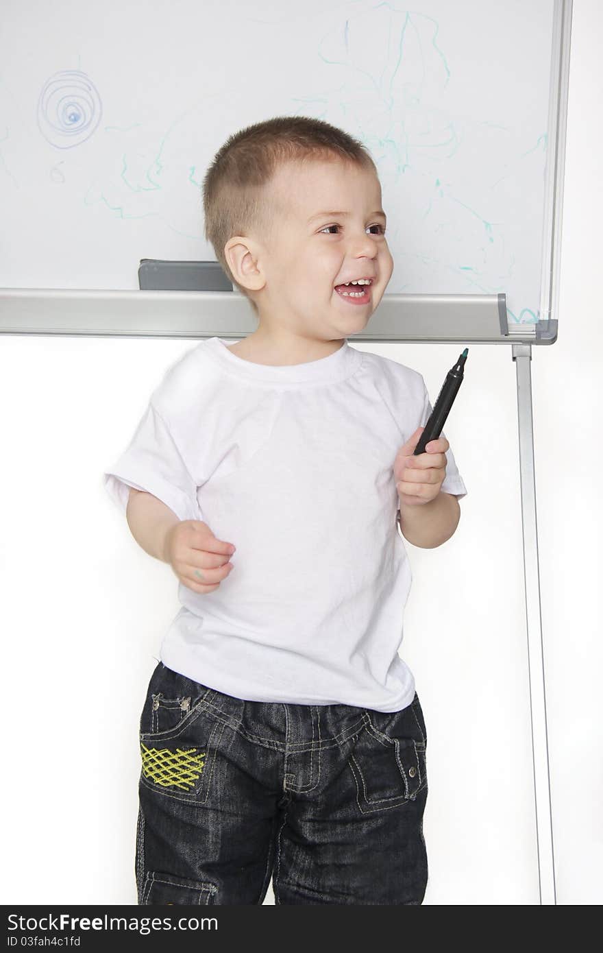 Smiling boy next to white board