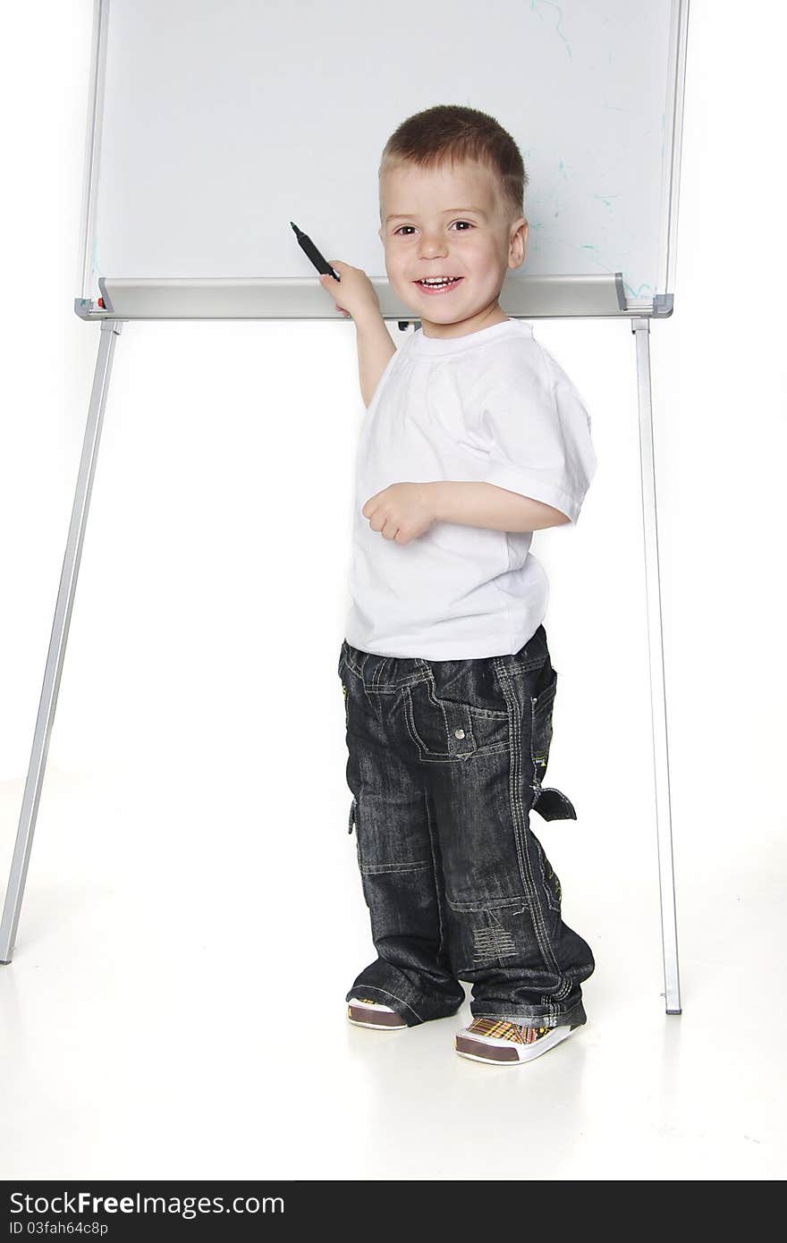 Smiling boy next to white board