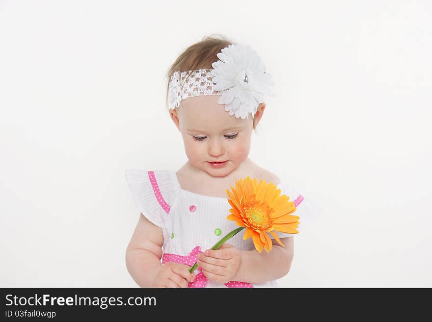 Beautiful toddler girl with flower