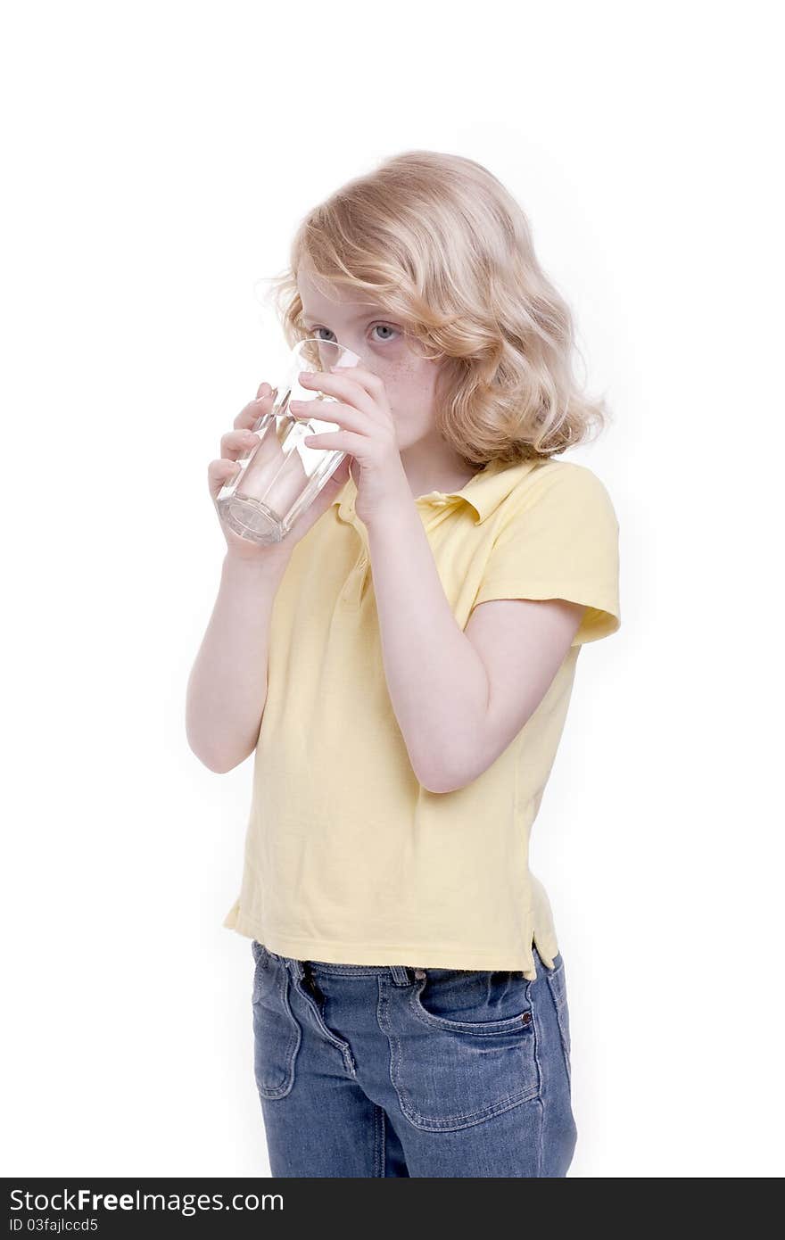 Small girl drinks the water from the water glass. Small girl drinks the water from the water glass