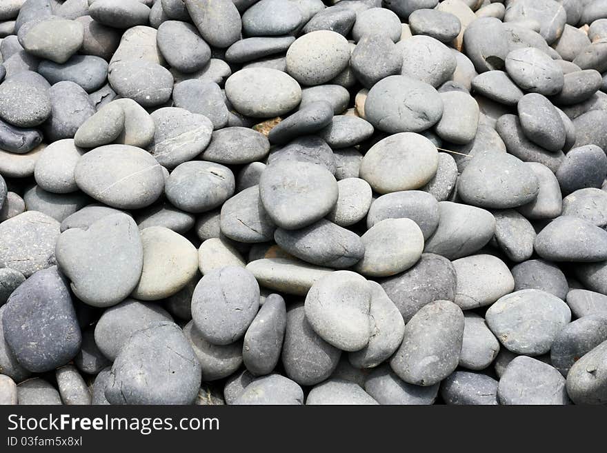 A pile of grey rounded stones. A pile of grey rounded stones.