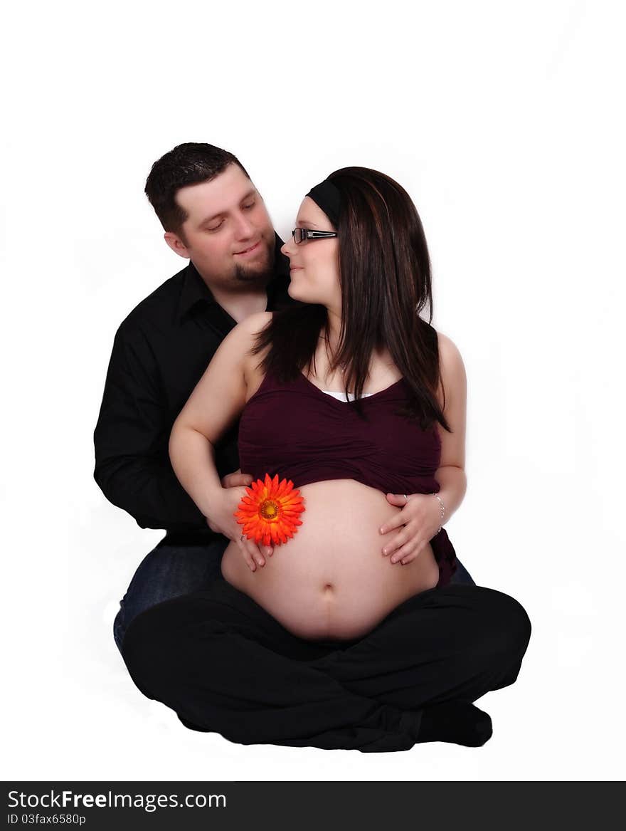 Happy expecting couple looking at each other with hands on her belly. isolated. Happy expecting couple looking at each other with hands on her belly. isolated