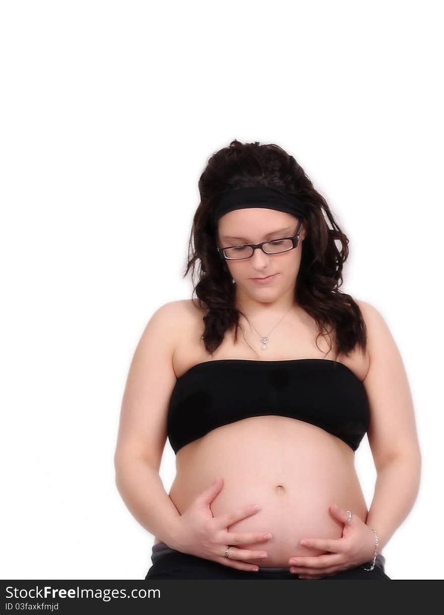 Gorgeous pregnant woman with hands on bare stomach looking down. isolated on white. Gorgeous pregnant woman with hands on bare stomach looking down. isolated on white