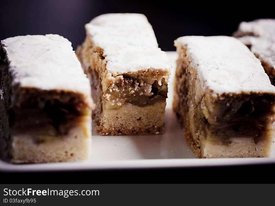 Homemade apple sponge cakes with cinnamon on the white plate. Homemade apple sponge cakes with cinnamon on the white plate